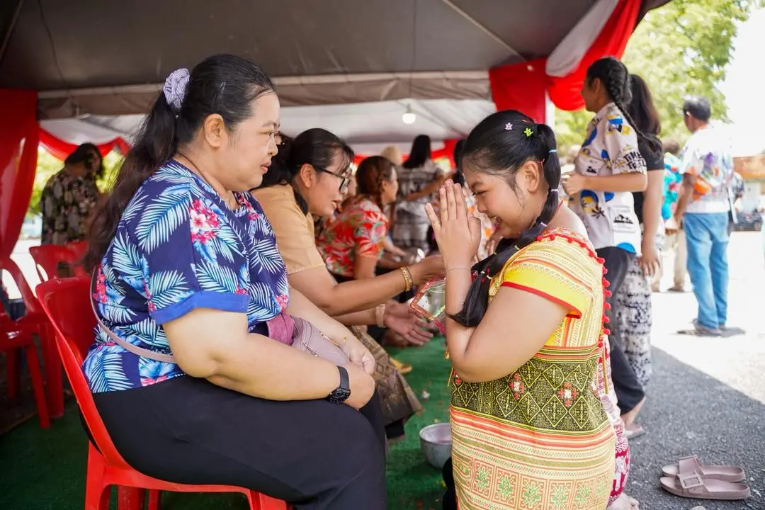 Generasi muda menunjukkan penghormatan kepada golongan lebih tua dalam sambutan Songkran masyarakat Siam.