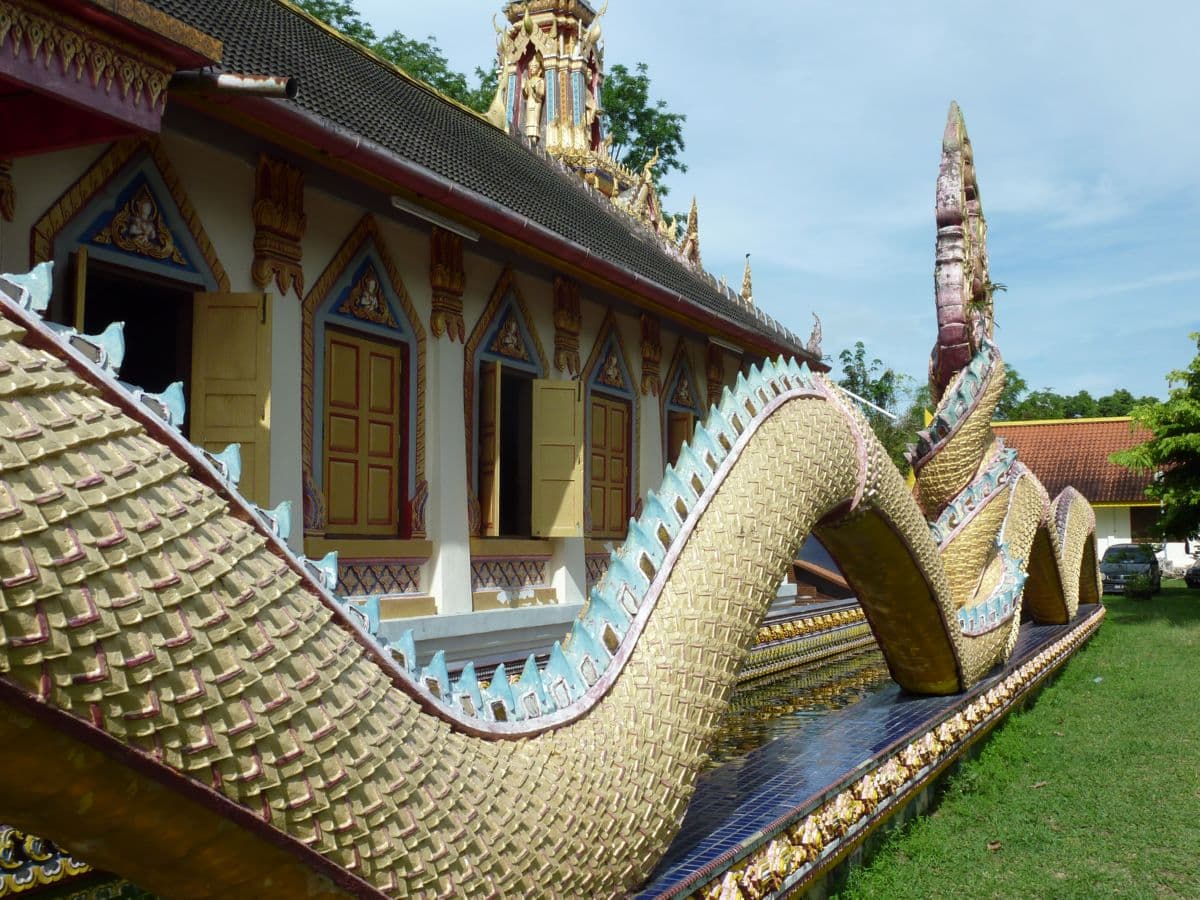 View of the dragon-boat shrine and temple moat at Wat Mai Suwankhiri, Tumpat, Kelantan