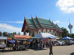 Wat Nikrodharam temple tower with adjacent market stalls, Alor Setar, Kedah